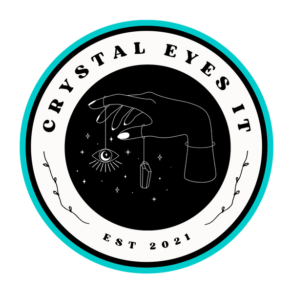 Hand holding evil eye and crystal 